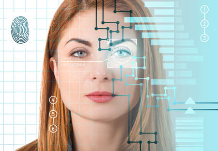 Businesswoman using facial recognition system for data protectionの写真素材