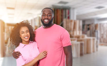 Portrait of happy African-American couple in modern carpet shopの写真素材