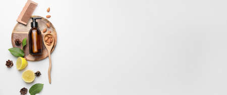 Composition with shampoo, natural ingredients and comb on white background with space for textの写真素材