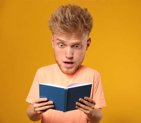 Stressed male student with big head on color backgroundの写真素材