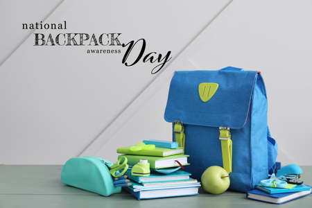 Schoolbag and stationery on table against gray background. National Backpack Awareness Dayの写真素材
