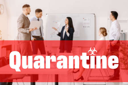 People in office with word QUARANTINE. Concept of Coronavirus epidemicの写真素材