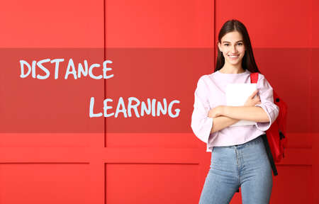 Beautiful female student on color background. Concept of distance learningの写真素材