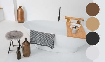 Bathtub with supplies in stylish interior. Different color patternsの写真素材