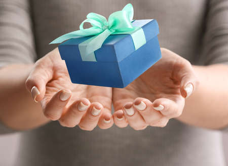 Young woman with gift, closeup