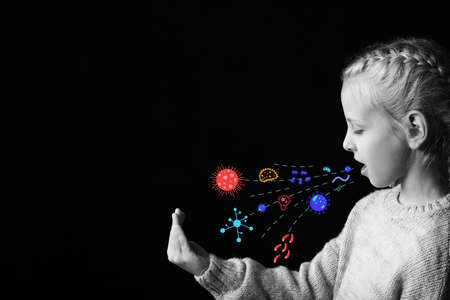 Coughing little girl on dark background. Concept of epidemicの写真素材