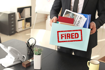 Fired worker packing things in officeの写真素材