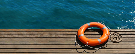 Lifebuoy ring on sea pier with space for text