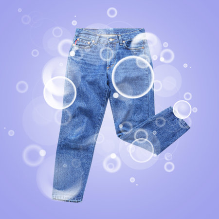 Clean pants with soap bubbles on color backgroundの写真素材