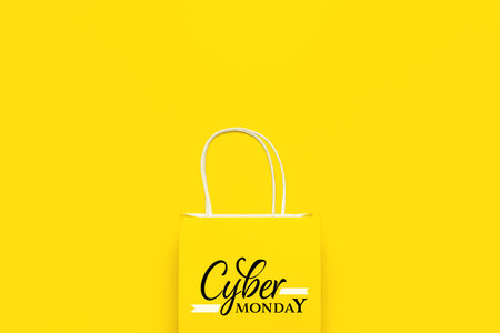 Paper shopping bag with text CYBER MONDAY on color backgroundの写真素材