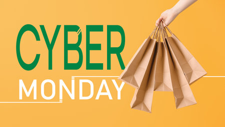 Female hand with paper shopping bags on color background. Concept of Cyber Mondayの写真素材