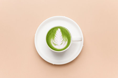Cup of matcha tea on color background