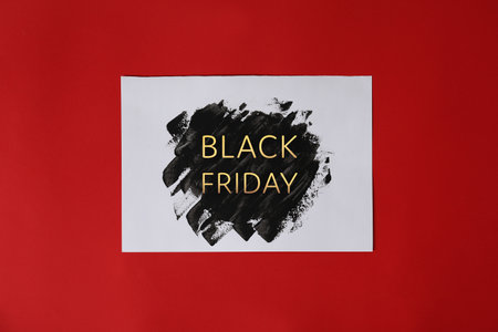 Paper sheet with text BLACK FRIDAY on color backgroundの写真素材