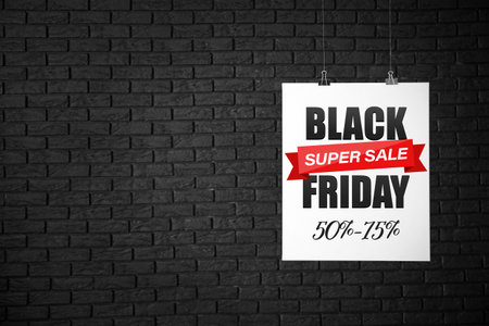 Poster with text BLACK SUPER SALE FRIDAY on dark brick background