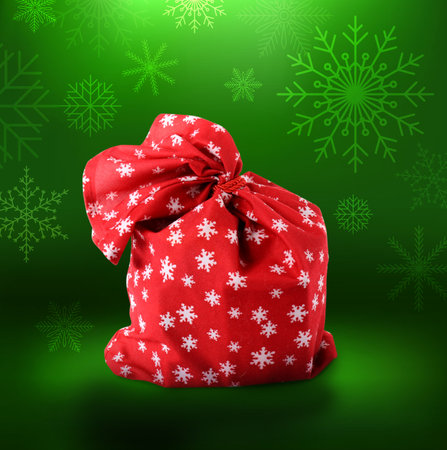 Santa Claus bag full of gifts on color backgroundの写真素材