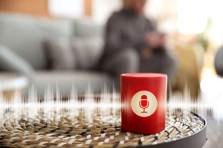 Smart home assistant device on table in roomの写真素材