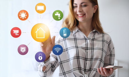 Woman using futuristic interface of smart home automationの写真素材