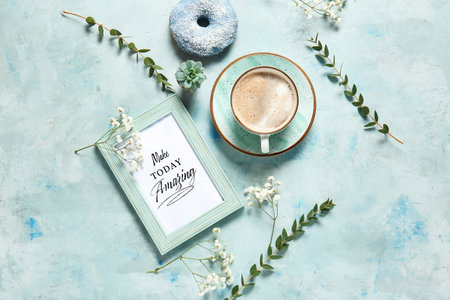 Cup of coffee, donut, flowers and frame with text MAKE TODAY AMAZING on color background