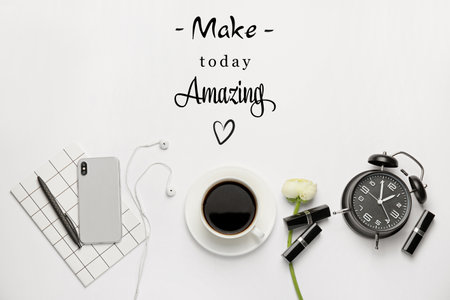 Composition with text MAKE TODAY AMAZING, cup of coffee, mobile phone, alarm clock and notebook on white backgroundの写真素材