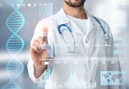 Male doctor using virtual screen in clinicの写真素材