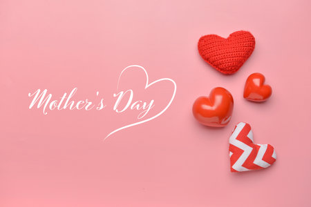 Text MOTHER'S DAY and beautiful hearts on color backgroundの写真素材