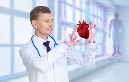 Male cardiologist using virtual screen in clinicの写真素材