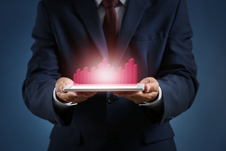 Business consultant with tablet computer on dark backgroundの写真素材