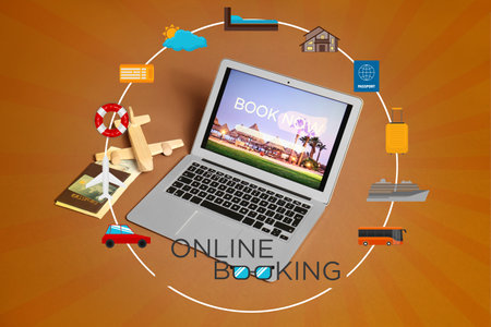 Open page of online booking service on screen of laptop on color backgroundの写真素材