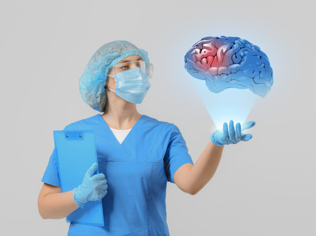 Female doctor with holographic projection of human brain on light background. Innovative technologies in medicineの写真素材