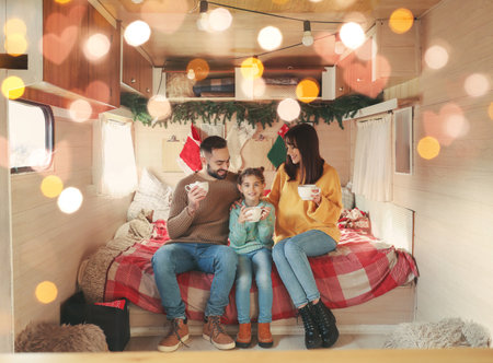 Happy family in motorhome on Christmas eveの写真素材