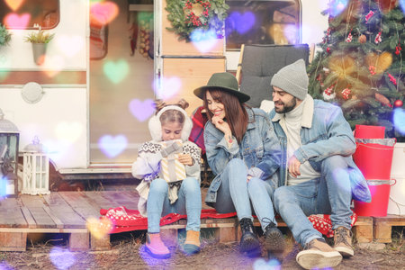 Happy family celebrating Christmas outdoorsの写真素材