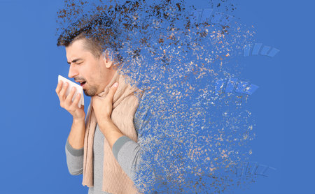 Coughing young man ill with flu on color backgroundの写真素材