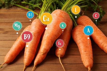 Fresh carrot with specified composition on table