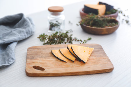 Tasty cheese with thyme on white wooden tableの写真素材