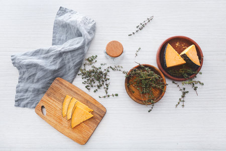 Tasty cheese with thyme on white wooden tableの写真素材