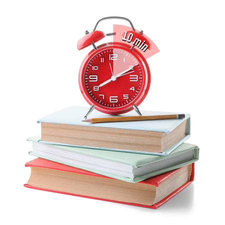 Alarm clock with timer for 10 minutes and books on white background. Time management conceptの写真素材