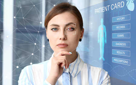Young woman with iris scanning and electronic patient record in clinic. Innovative technologies in medicineの写真素材