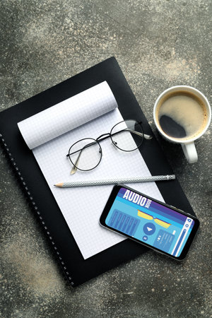 Modern smartphone with open page of audiobook application on screen