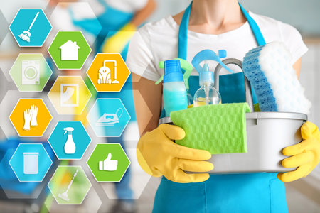 Female janitor with supplies and cleaning service iconsの写真素材