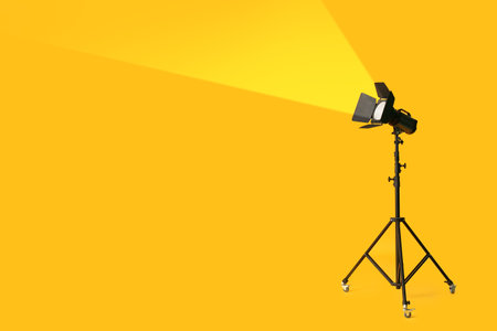 Modern lighting equipment for photo studio on yellow backgroundの写真素材