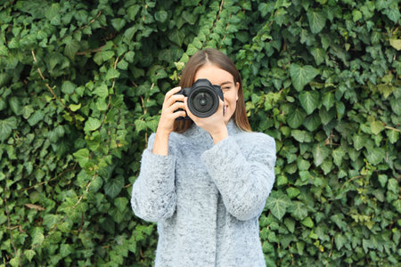 Young female photographer outdoors