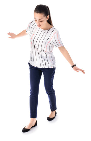 Balancing young businesswoman on white backgroundの写真素材