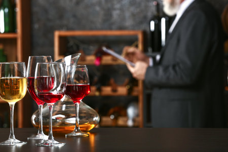 Table with wineglasses and decanter on table in cellarの写真素材