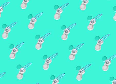 Containers with contact lenses and tweezers on color background