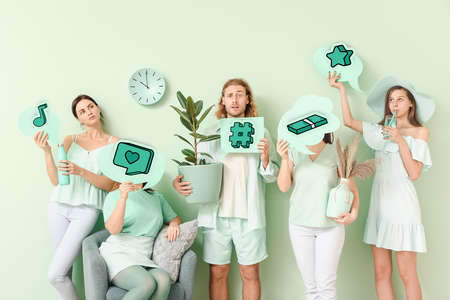 Group of young people holding speech bubbles with different drawings on color backgroundの写真素材