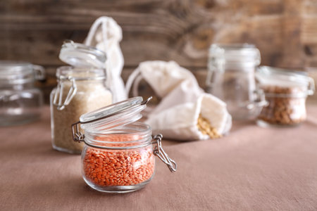 Glass jar with lentils on kitchen tableの写真素材