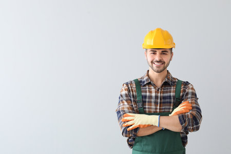 Male worker on light background