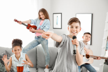 Teenage musicians playing and singing at homeの写真素材