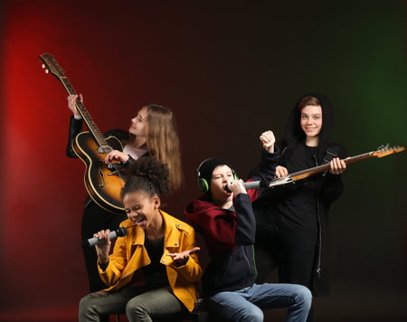 Band of teenage musicians on dark backgroundの写真素材