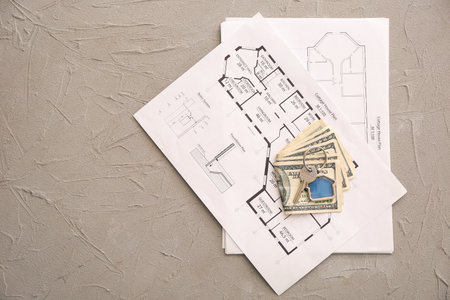 Drawings of house, key and money on table. Concept of buying real estateの写真素材